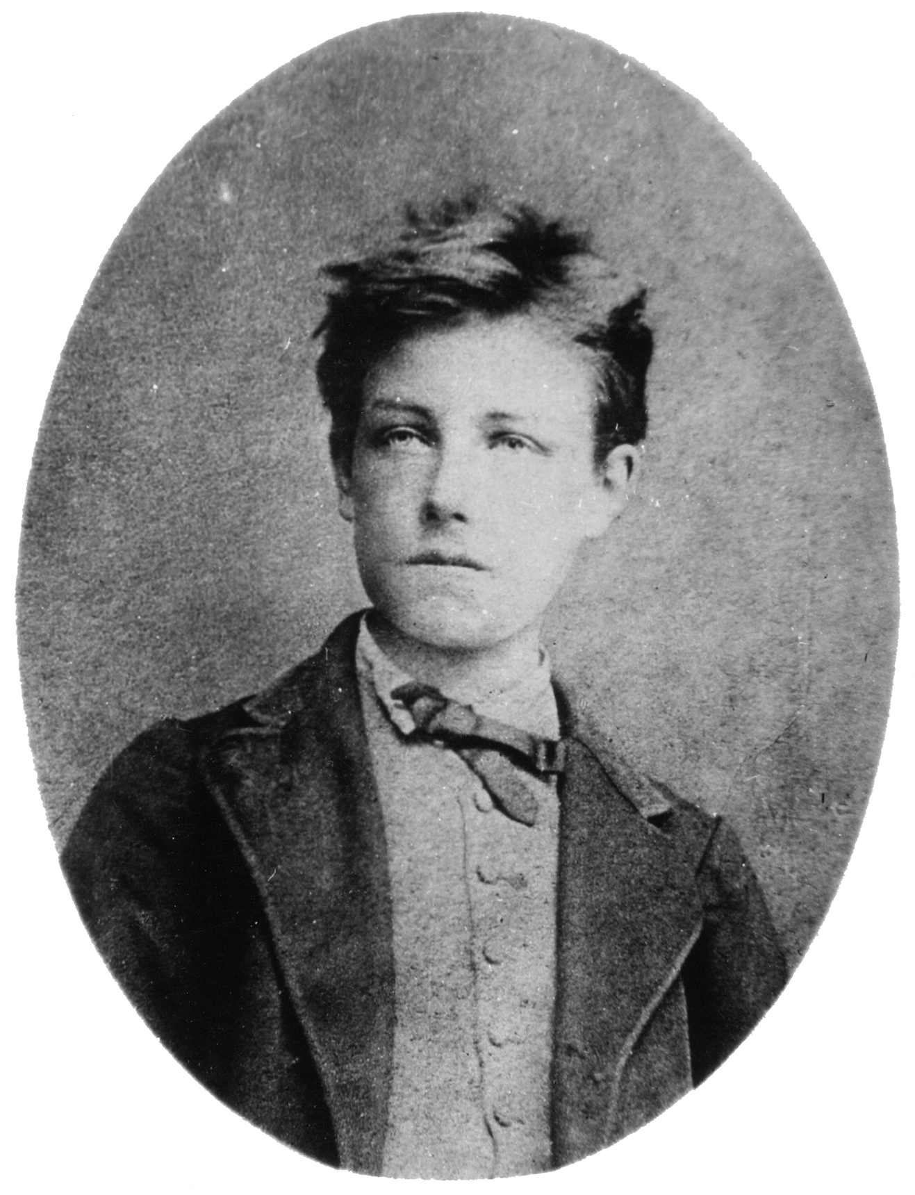 The photographic portrait of Arthur Rimbaud was taken when he was sixteen. The portrait shows the head and torso of a young man with tousled hair, wearing a tie, vest, and jacket. His face is slightly angled and he is looking to the left; his face is serious and his lips are closed.