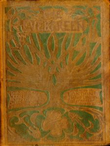 Front cover is brown leather decorated with a tree motif. Centred at the top of the image is the title, “The Evergreen” in capital letters. A large tree and its branches take up the majority of the cover. On the center bottom left of the cover, beside the trunk of the tree, it reads, “published in EDINBURGH by Patrick Geddes Colleagues at the Lawnmarket…” The text continues on the right side of the trunk. It reads, “And also in LONDON by T. Fisher Unwin Paternoster Square E. C.” by Patrick Geddes & Colleagues at the Lawnmarket of Edinburgh.” The roots of the tree extend below this text to the bottom of the frame of the image. Intertwined with the roots there are flowers. On the bottom center of the cover, there is a decorative pattern of four swirls. The brown leather cover is embossed in muted colours of green and red-ish brown. Image is vertically displayed.