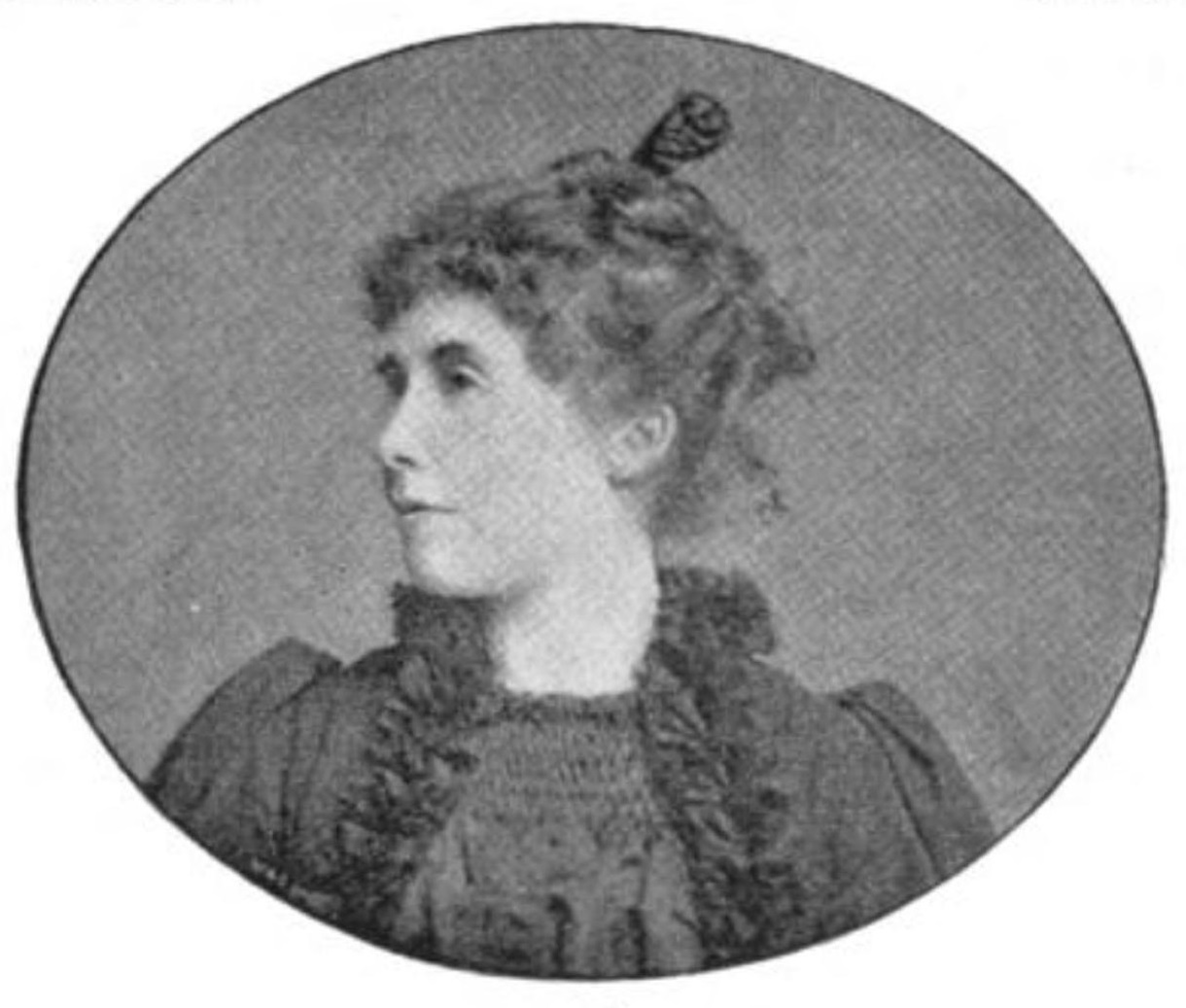 The black-and-white half-tone print is a head-and-shoulders view of Ella D’Arcy as a young woman, shown in three-quarter profile. Her hair is swept up to the top of her head and held with a decorative comb. She is wearing a dark dress with ruched neckline and puffed sleeves.